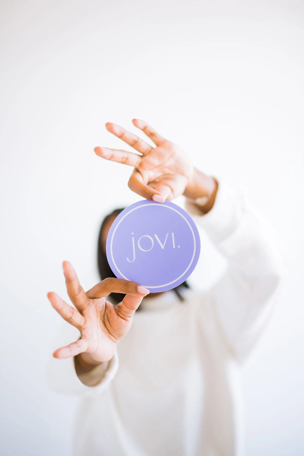 Jovi brand coaster held up to camera